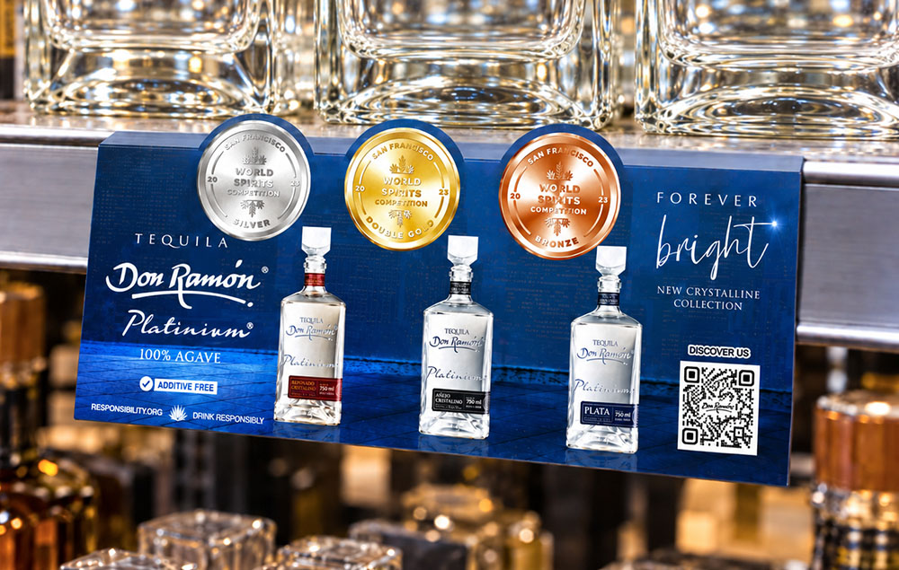 Award medallion shelf talker on a retail shelf beside the winning bottle